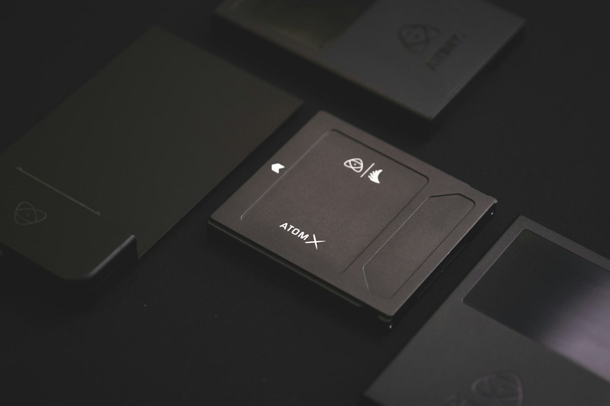A compact solid-state drive rests among dark storage accessories.